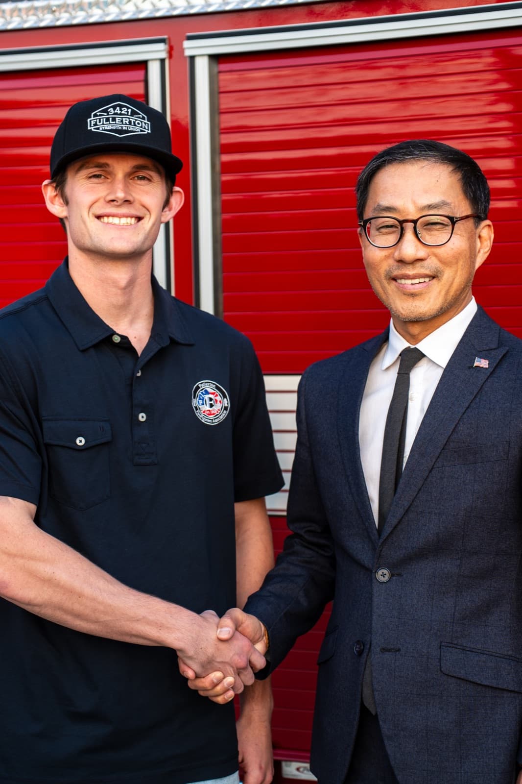 Fred Jung shaking hands with Fullerton firefighter