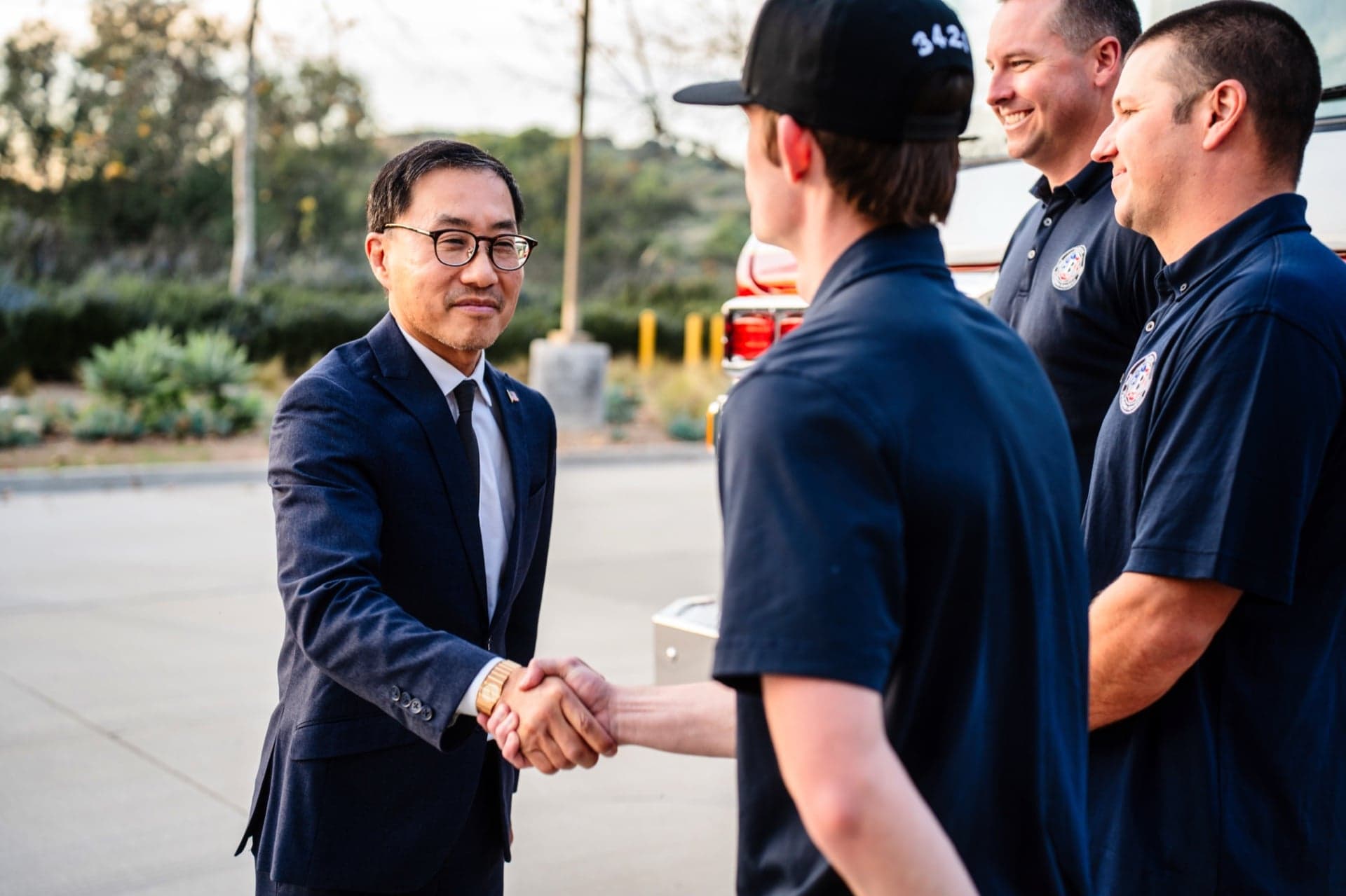Fred Jung shaking hands with a firefighter